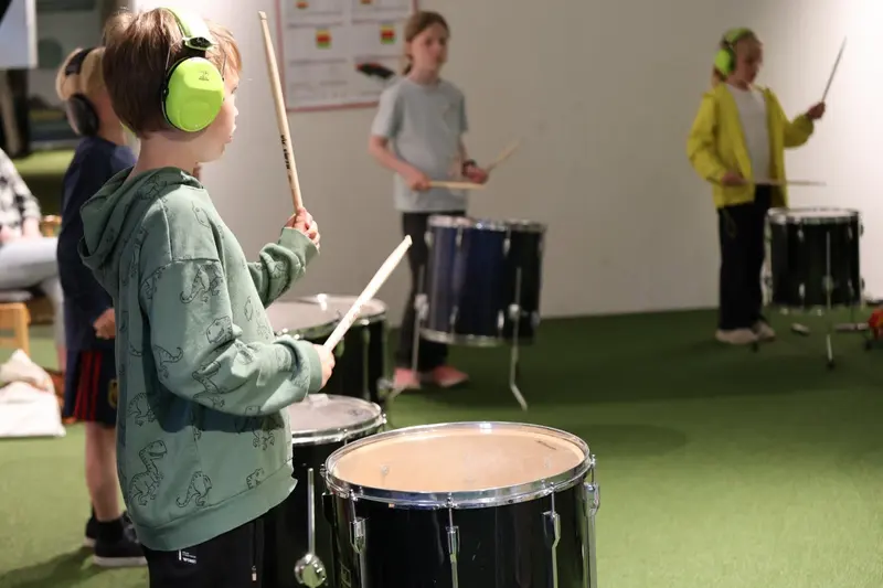 Barn spiller på trommer på rytmegøy
